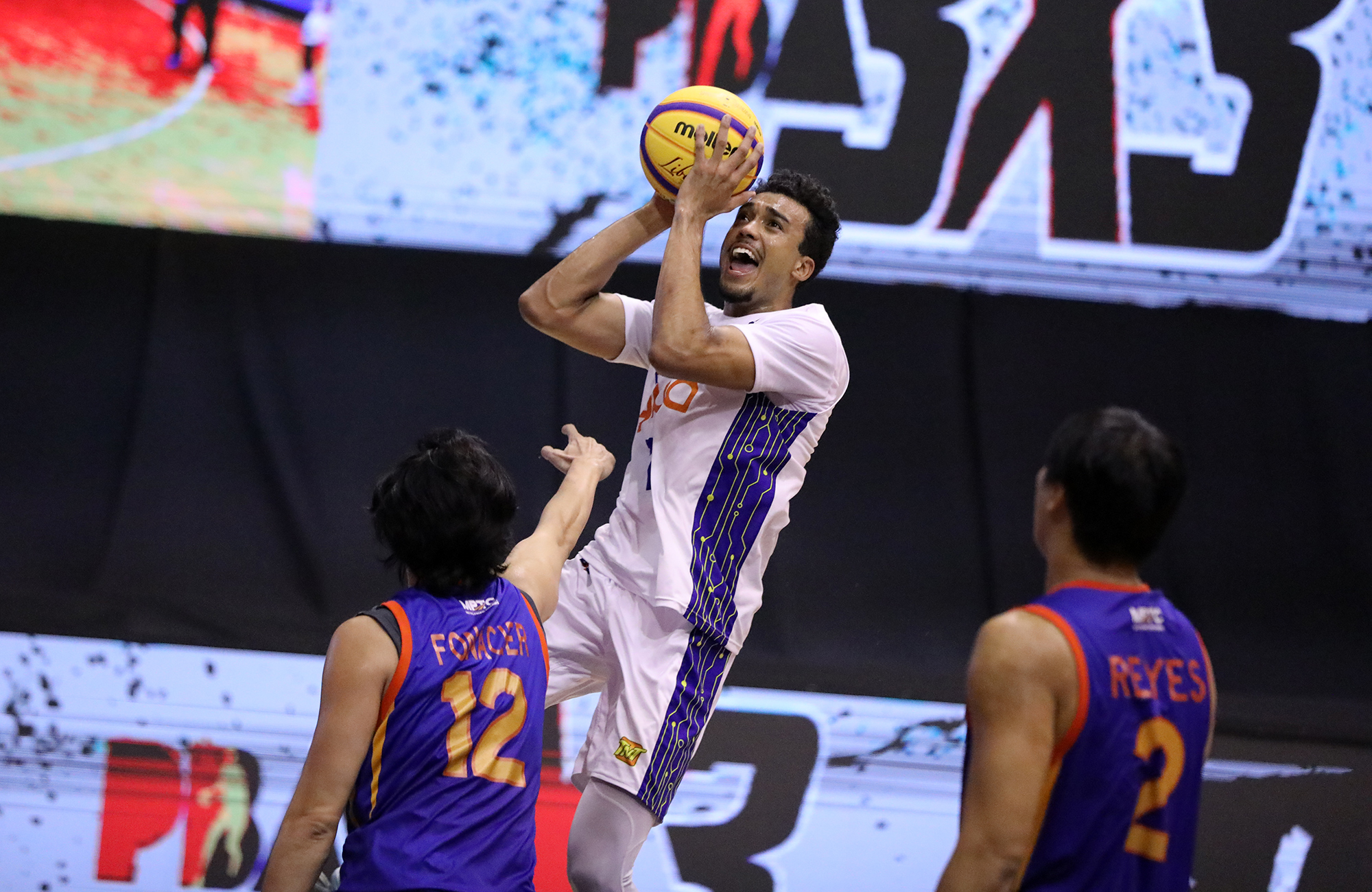 FILE–Jeremiah Gray of TNT drives against Cavitex veteran Larry Fonacier as the third leg of the PBA 3x3 tournament got going on Saturday
