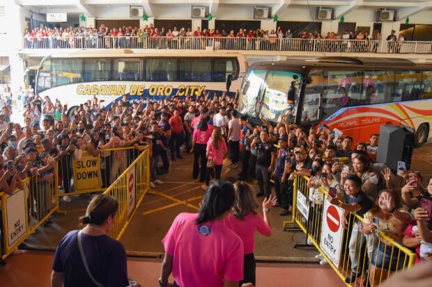 Players are met by fans as they arrived in Cagayan de Oro for a provincial game.
